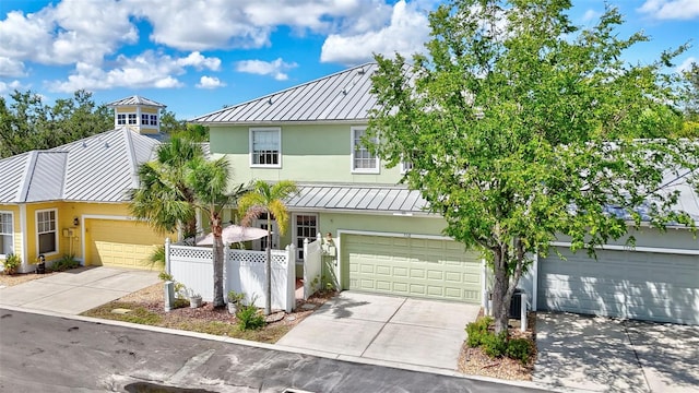 5518 Luminar Pointe Ln, Apollo Beach, FL 33572 - view of front of property with a standing seam roof, a metal roof, stucco siding, and driveway