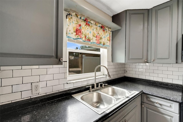 915 S Miller Rd, Valrico, FL 33594 - kitchen featuring gray cabinetry, dark countertops, and decorative backsplash