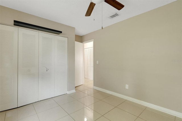 915 S Miller Rd, Valrico, FL 33594 - unfurnished bedroom featuring a closet, light tile patterned flooring, and ceiling fan