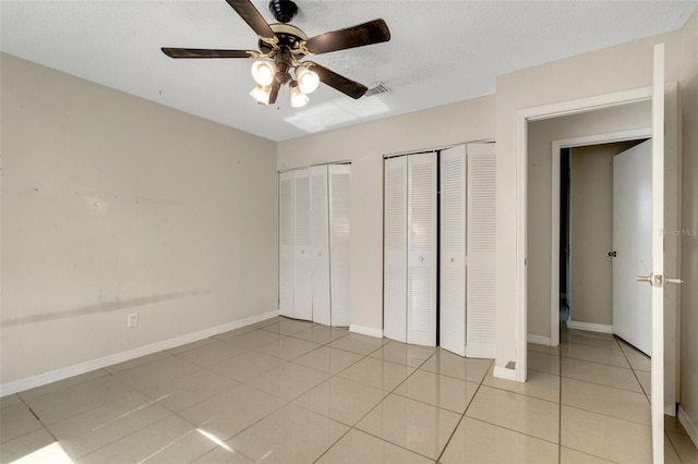 915 S Miller Rd, Valrico, FL 33594 - unfurnished bedroom with two closets, light tile patterned floors, and ceiling fan