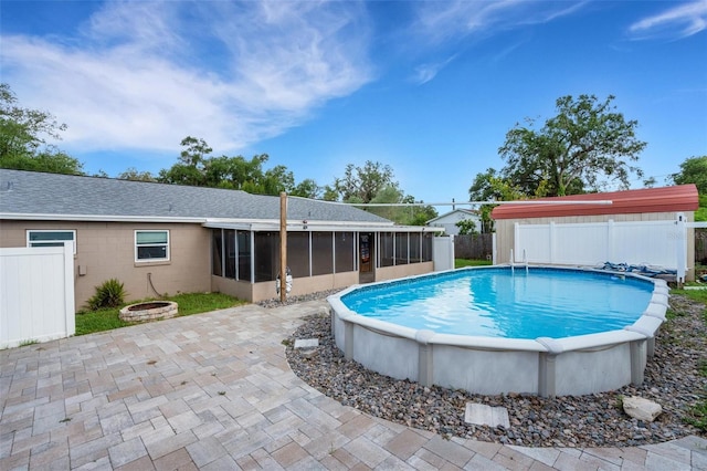915 S Miller Rd, Valrico, FL 33594 - view of swimming pool featuring a sunroom, a fenced backyard, a patio, and an outdoor fire pit