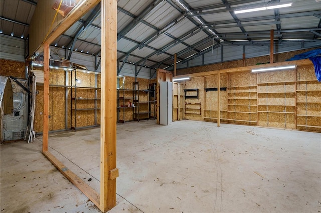 915 S Miller Rd, Valrico, FL 33594 - miscellaneous room featuring a garage, concrete flooring, high vaulted ceiling, and metal wall