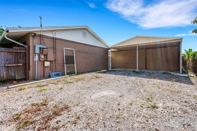 915 S Miller Rd, Valrico, FL 33594 - rear view of property featuring a detached carport and concrete block siding