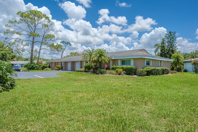 1510 Palmer Ct, Palm Harbor, FL 34685 - single story home with a garage, concrete driveway, a front yard, and stucco siding
