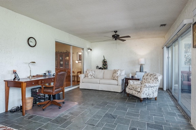 1510 Palmer Ct, Palm Harbor, FL 34685 - living area with ceiling fan, an office area, a textured ceiling, stone finish flooring, and a textured wall
