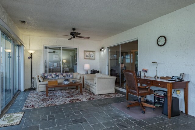 1510 Palmer Ct, Palm Harbor, FL 34685 - living room featuring a textured ceiling, ceiling fan, an office area, and a textured wall