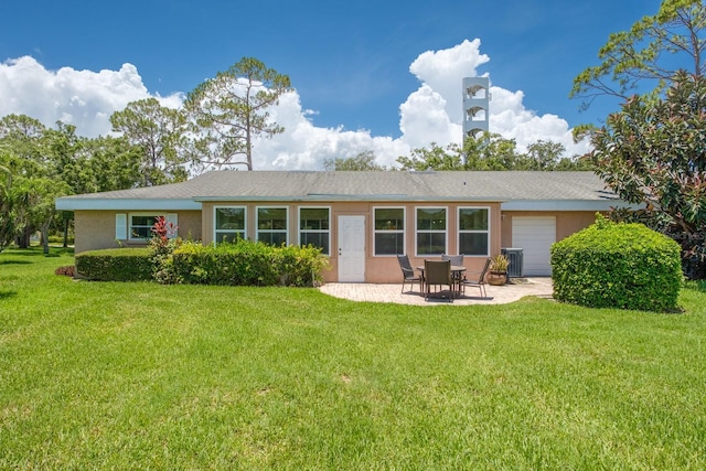 1510 Palmer Ct, Palm Harbor, FL 34685 - back of house featuring a garage, stucco siding, a patio area, and a yard
