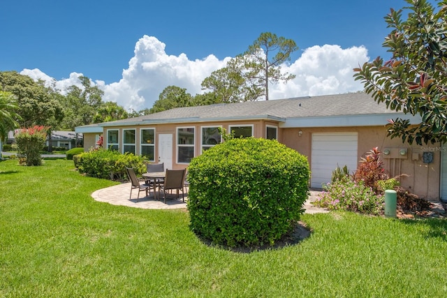 1510 Palmer Ct, Palm Harbor, FL 34685 - rear view of house featuring an attached garage, a yard, a patio area, stucco siding, and a shingled roof