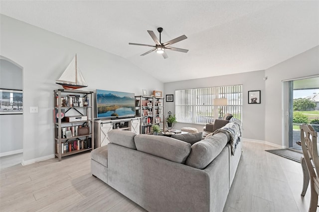 2306 Emerald Lake Dr, Sun City Center, FL 33573 - living area with lofted ceiling, light wood-type flooring, a ceiling fan, and arched walkways