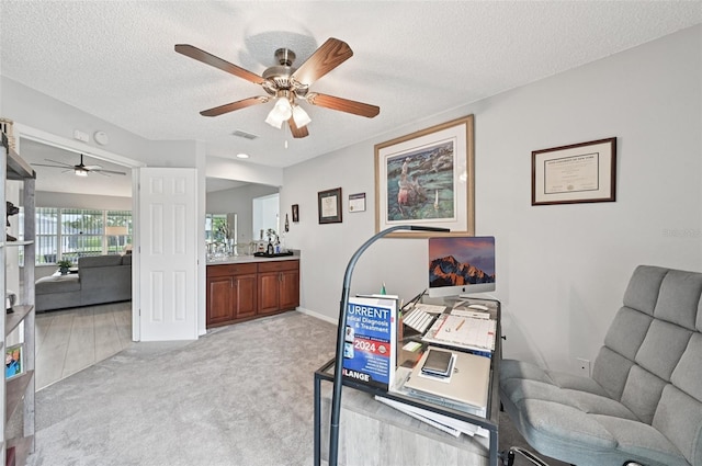 2306 Emerald Lake Dr, Sun City Center, FL 33573 - office featuring ceiling fan, a textured ceiling, and light carpet