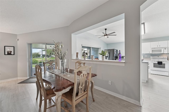 2306 Emerald Lake Dr, Sun City Center, FL 33573 - dining area featuring light wood finished floors, ceiling fan, and lofted ceiling