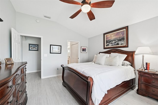 2306 Emerald Lake Dr, Sun City Center, FL 33573 - bedroom featuring vaulted ceiling, light wood finished floors, ensuite bathroom, and a ceiling fan