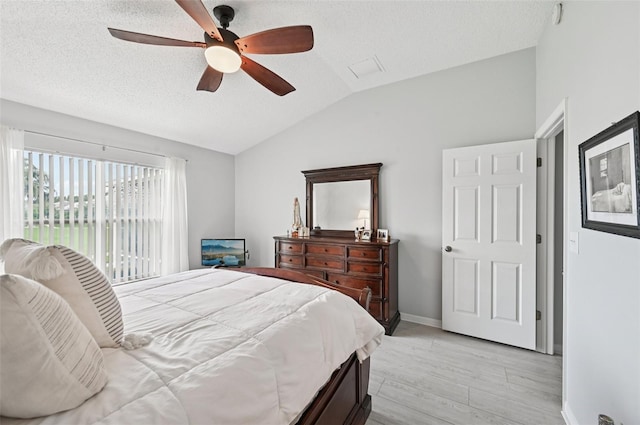 2306 Emerald Lake Dr, Sun City Center, FL 33573 - bedroom with lofted ceiling, light wood-type flooring, access to outside, a textured ceiling, and ceiling fan