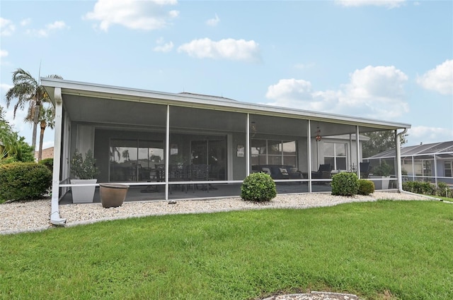 2306 Emerald Lake Dr, Sun City Center, FL 33573 - rear view of property with a lawn and a sunroom