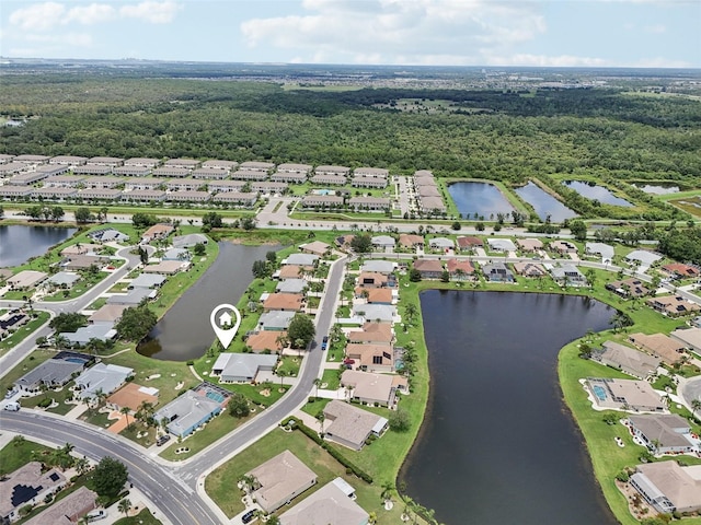 2306 Emerald Lake Dr, Sun City Center, FL 33573 - aerial view of property and surrounding area featuring nearby suburban area and a nearby body of water