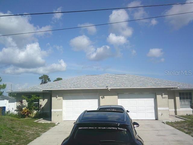 2429/2431 Quentin Ave S, Lehigh Acres, FL 33973 - garage featuring driveway