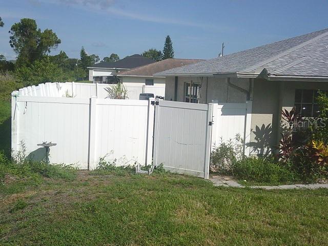 2429/2431 Quentin Ave S, Lehigh Acres, FL 33973 - view of yard featuring a gate