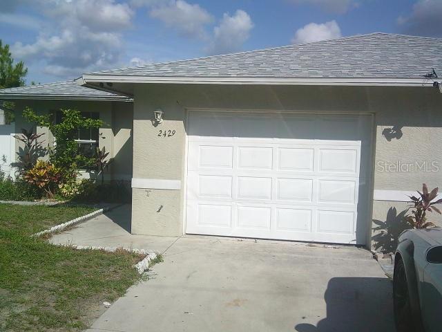 2429/2431 Quentin Ave S, Lehigh Acres, FL 33973 - garage with concrete driveway
