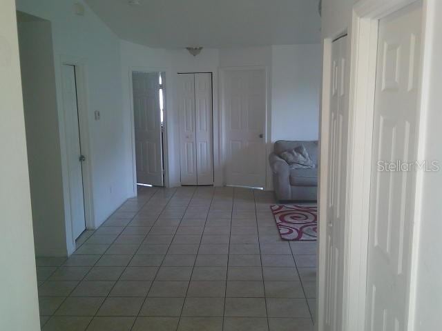 2429/2431 Quentin Ave S, Lehigh Acres, FL 33973 - hallway featuring light tile patterned flooring