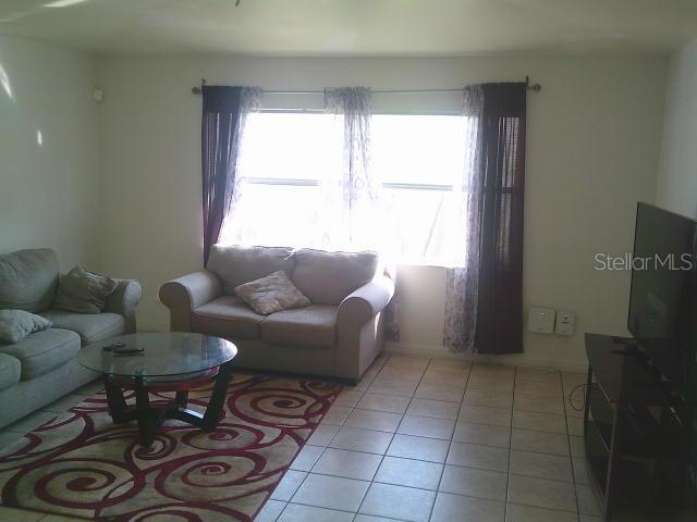 2429/2431 Quentin Ave S, Lehigh Acres, FL 33973 - living room featuring light tile patterned floors