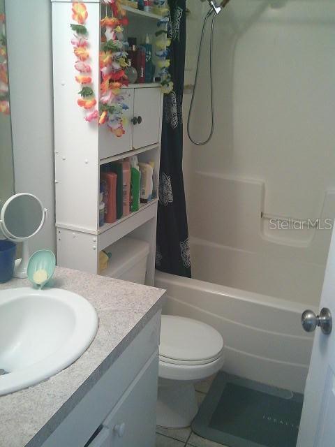 2429/2431 Quentin Ave S, Lehigh Acres, FL 33973 - bathroom featuring vanity, shower / bath combo, and tile patterned floors