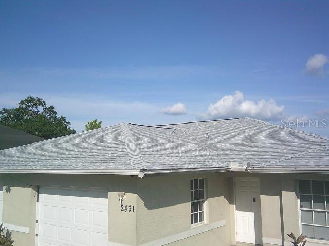 2429/2431 Quentin Ave S, Lehigh Acres, FL 33973 - exterior view of a shingled roof and stucco siding