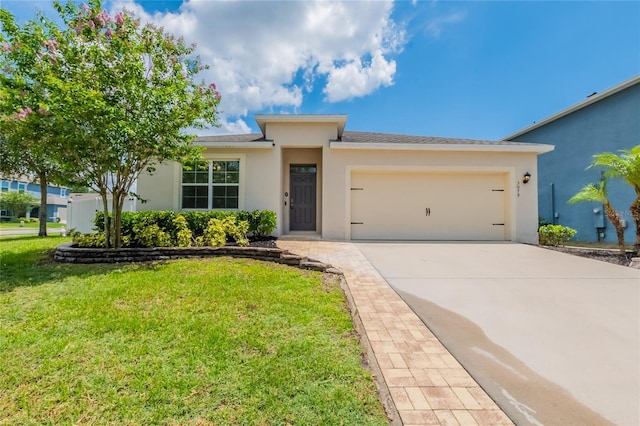 3079 Bethpage Loop, Mount Dora, FL 32757 - ranch-style home featuring an attached garage, stucco siding, concrete driveway, and a front lawn