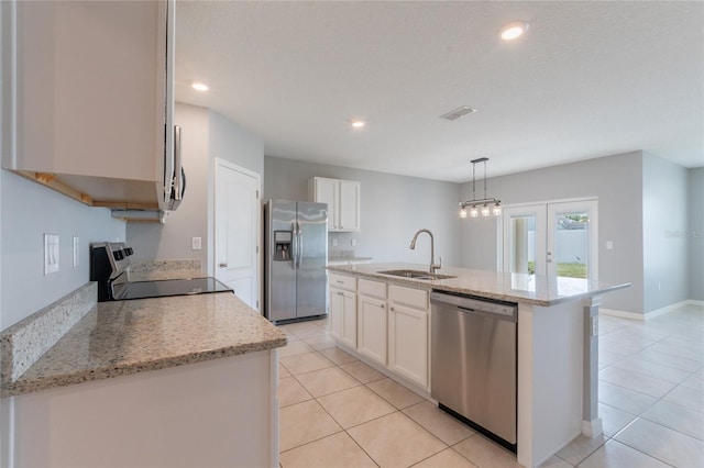 3079 Bethpage Loop, Mount Dora, FL 32757 - kitchen with stainless steel appliances, light tile patterned floors, white cabinetry, a kitchen island with sink, and recessed lighting