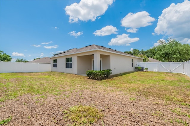 3079 Bethpage Loop, Mount Dora, FL 32757 - back of property featuring stucco siding, a fenced backyard, roof mounted solar panels, and a gate