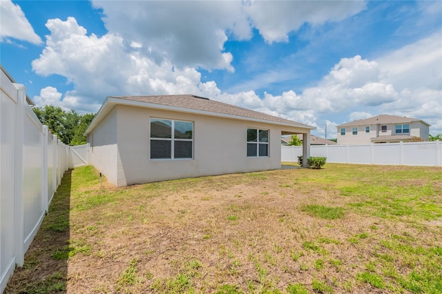 3079 Bethpage Loop, Mount Dora, FL 32757 - rear view of property with stucco siding, a fenced backyard, and a shingled roof