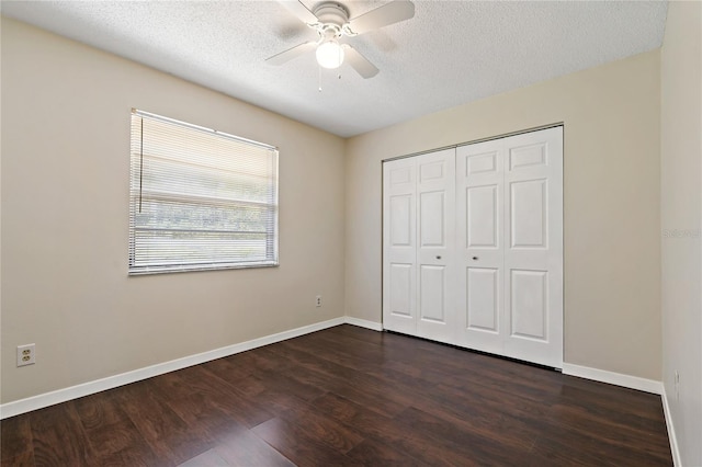 2901 Bay View Dr, Safety Harbor, FL 34695 - unfurnished bedroom with dark wood-style floors, a textured ceiling, a closet, and ceiling fan