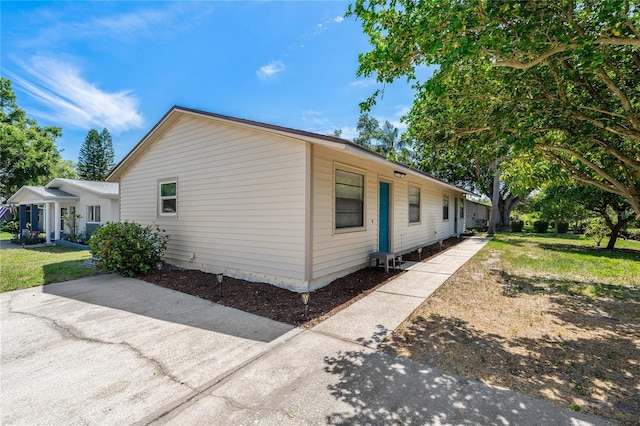 2901 Bay View Dr, Safety Harbor, FL 34695 - view of side of property with a lawn