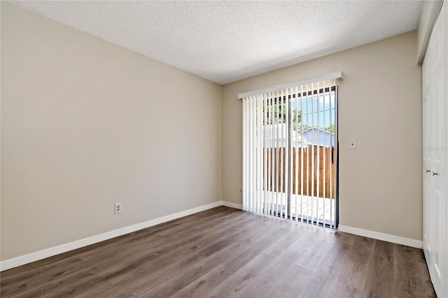 2901 Bay View Dr, Safety Harbor, FL 34695 - unfurnished room with wood finished floors and a textured ceiling