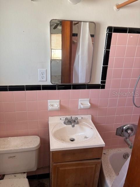150 147th Ave E, Madeira Beach, FL 33708 - full bath with vanity, tile walls, and  shower combination