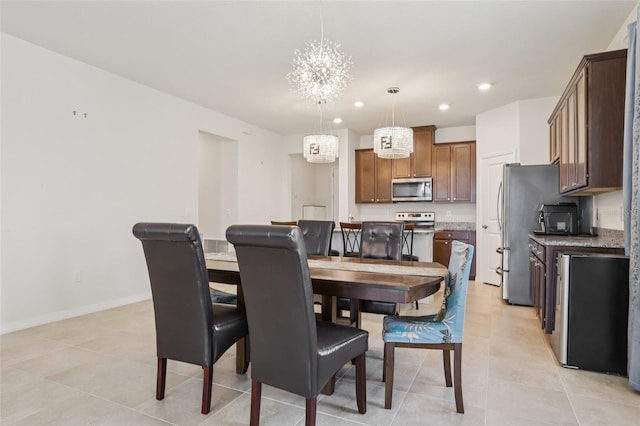 13515 Palmera Vista Dr, Riverview, FL 33579 - dining area featuring a chandelier, light tile patterned floors, and recessed lighting