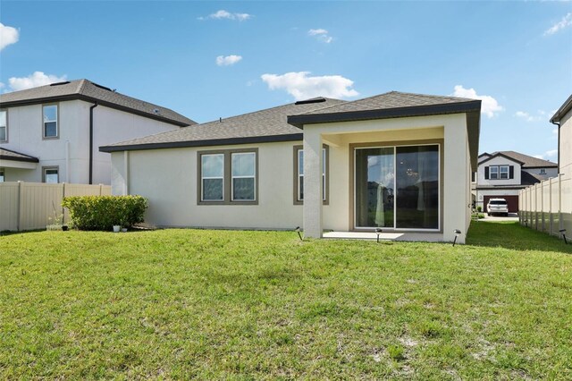 13515 Palmera Vista Dr, Riverview, FL 33579 - back of house featuring stucco siding and roof with shingles