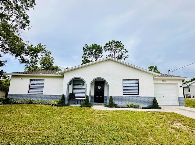 13186 Thrush St, Spring Hill, FL 34609 - view of front of house with brick siding, a front lawn, a garage, and concrete driveway