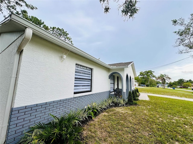 13186 Thrush St, Spring Hill, FL 34609 - view of home's exterior with a yard, stucco siding, and brick siding