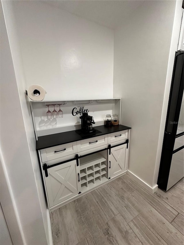 13186 Thrush St, Spring Hill, FL 34609 - detailed view of wood finished floors and freestanding refrigerator