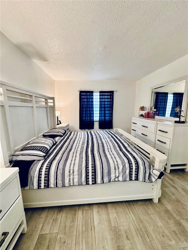 13186 Thrush St, Spring Hill, FL 34609 - bedroom featuring wood finished floors and a textured ceiling
