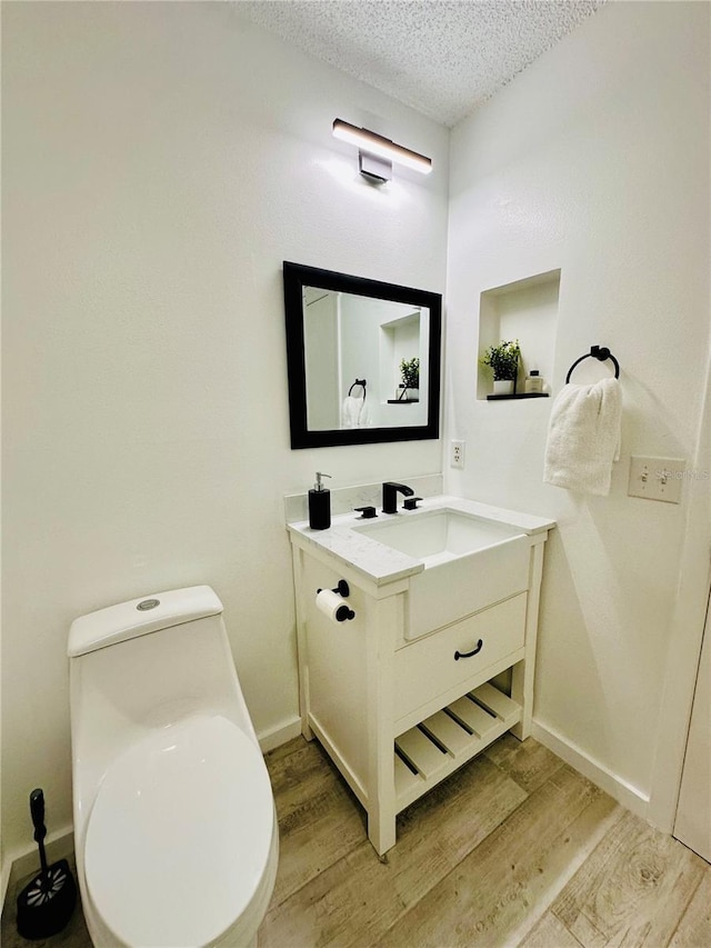 13186 Thrush St, Spring Hill, FL 34609 - half bath featuring wood finished floors, vanity, and a textured ceiling