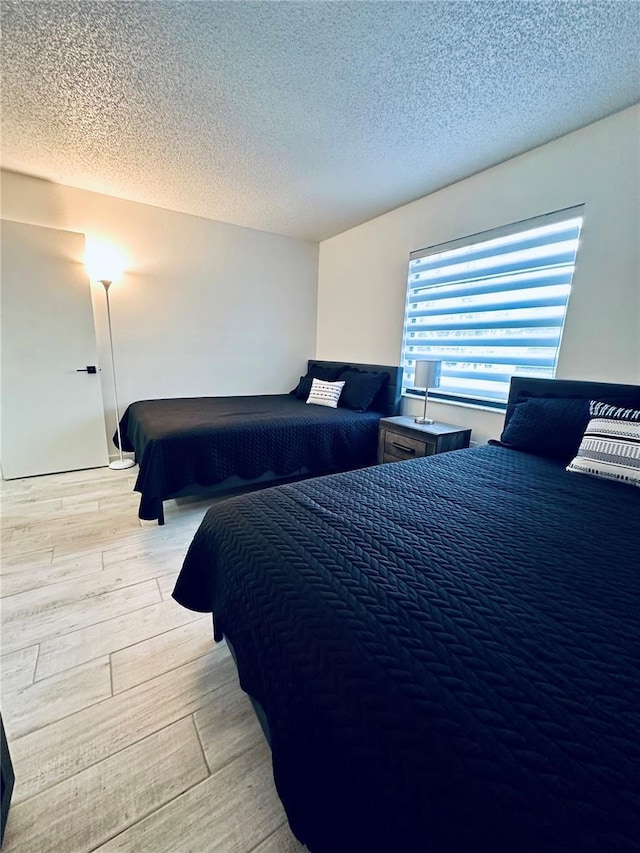 13186 Thrush St, Spring Hill, FL 34609 - bedroom with a textured ceiling and light wood finished floors