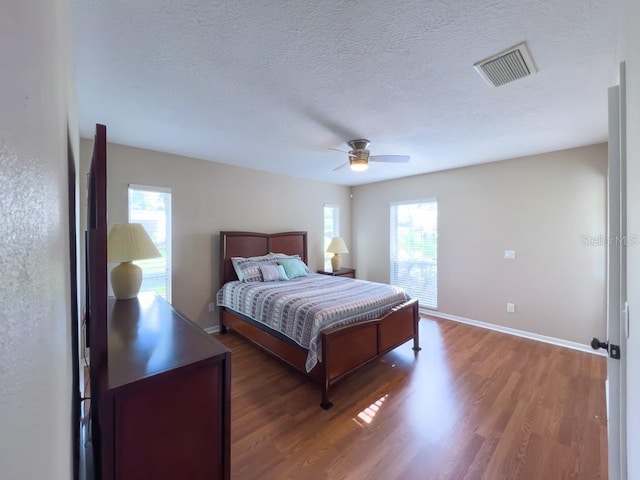4404 Hickory Branch Ct, Brandon, FL 33511 - bedroom with wood finished floors, a textured ceiling, and a ceiling fan