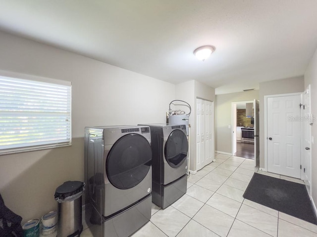 4404 Hickory Branch Ct, Brandon, FL 33511 - washroom featuring washing machine and dryer, light tile patterned floors, and water heater