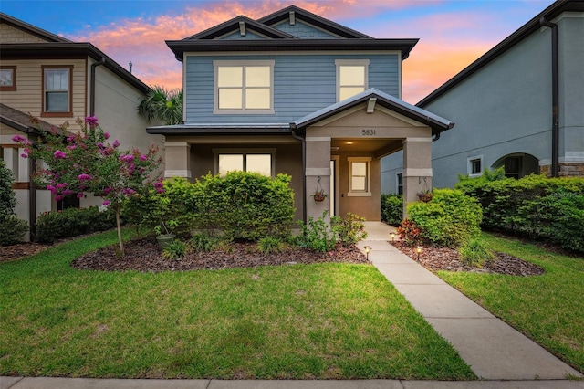 5831 Caldera Ridge Dr, Lithia, FL 33547 - view of front facade featuring a front lawn, covered porch, and stucco siding