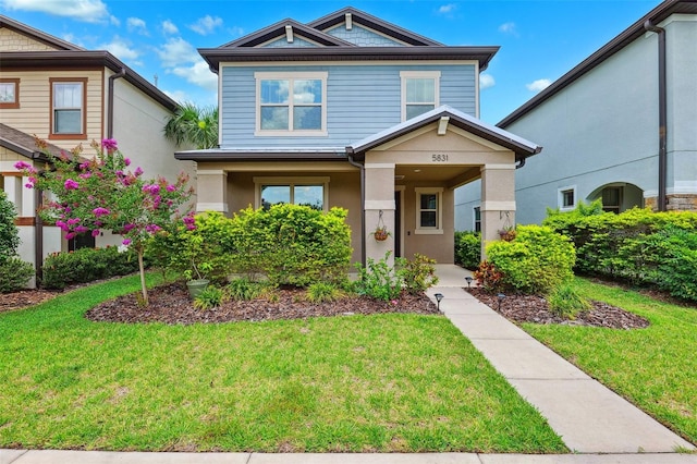 5831 Caldera Ridge Dr, Lithia, FL 33547 - view of front of home featuring a front yard, covered porch, and stucco siding