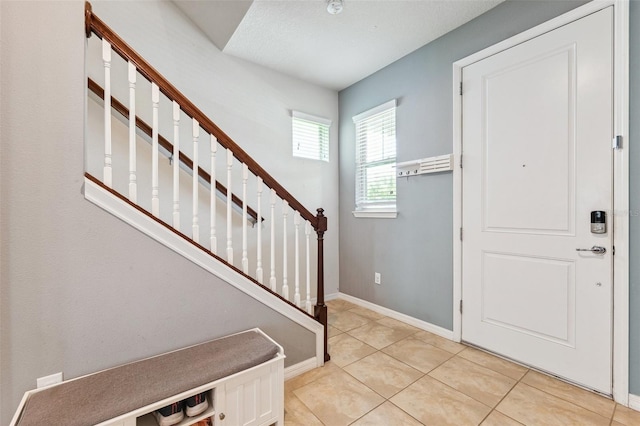 5831 Caldera Ridge Dr, Lithia, FL 33547 - foyer featuring stairway and light tile patterned floors
