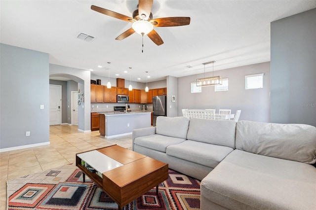 5831 Caldera Ridge Dr, Lithia, FL 33547 - living room featuring ceiling fan, arched walkways, light tile patterned floors, and recessed lighting
