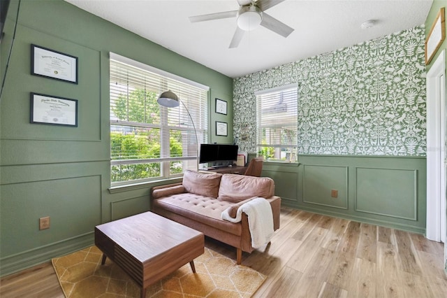 5831 Caldera Ridge Dr, Lithia, FL 33547 - living area featuring wallpapered walls, a decorative wall, light wood-style floors, healthy amount of natural light, and ceiling fan