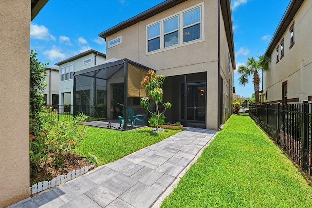 5831 Caldera Ridge Dr, Lithia, FL 33547 - back of property with a patio area, stucco siding, and glass enclosure
